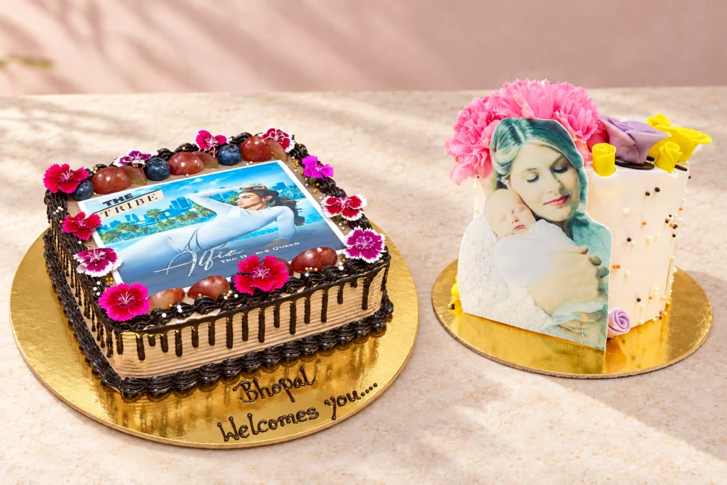 Two original photo cakes with preserved printed artwork in an edited setting
